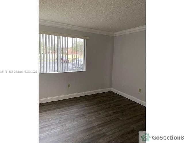 empty room with baseboards, a textured ceiling, dark wood-style floors, and crown molding