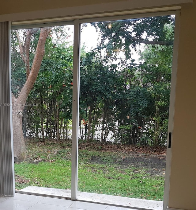 doorway to outside with tile patterned flooring