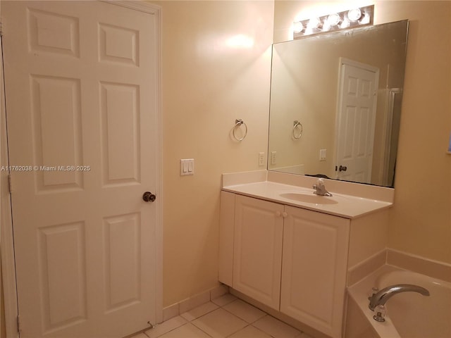 full bathroom featuring tile patterned floors, baseboards, a bath, and vanity