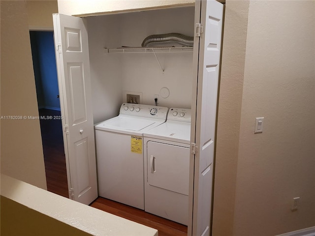 laundry area with laundry area, wood finished floors, and separate washer and dryer