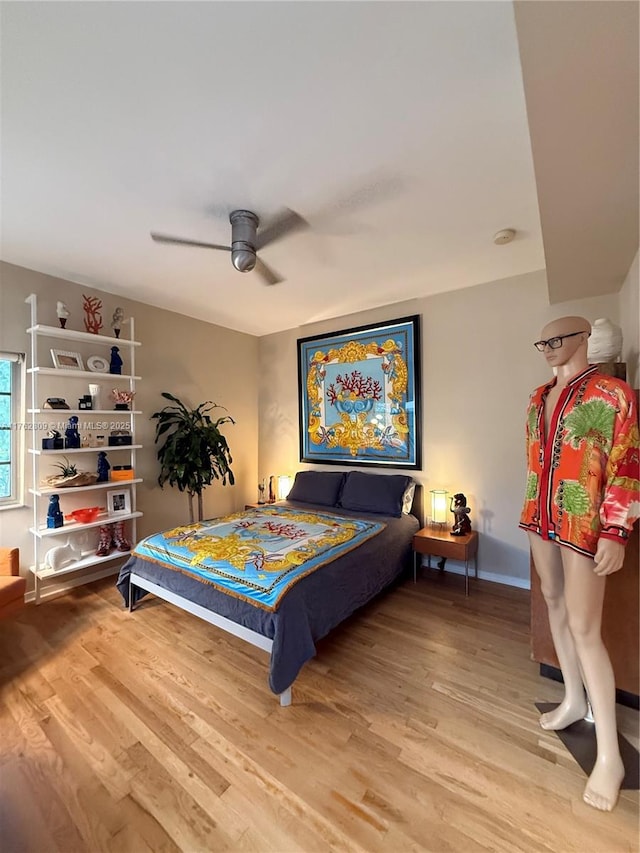 bedroom with baseboards, wood finished floors, and a ceiling fan