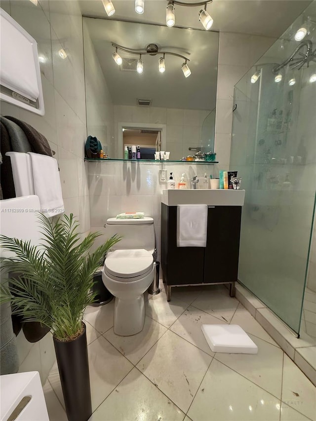 1600 Michigan Ave Unit 1, Miami Beach, FL 33139 - bathroom with tile walls, a shower stall, vanity, and tile patterned flooring