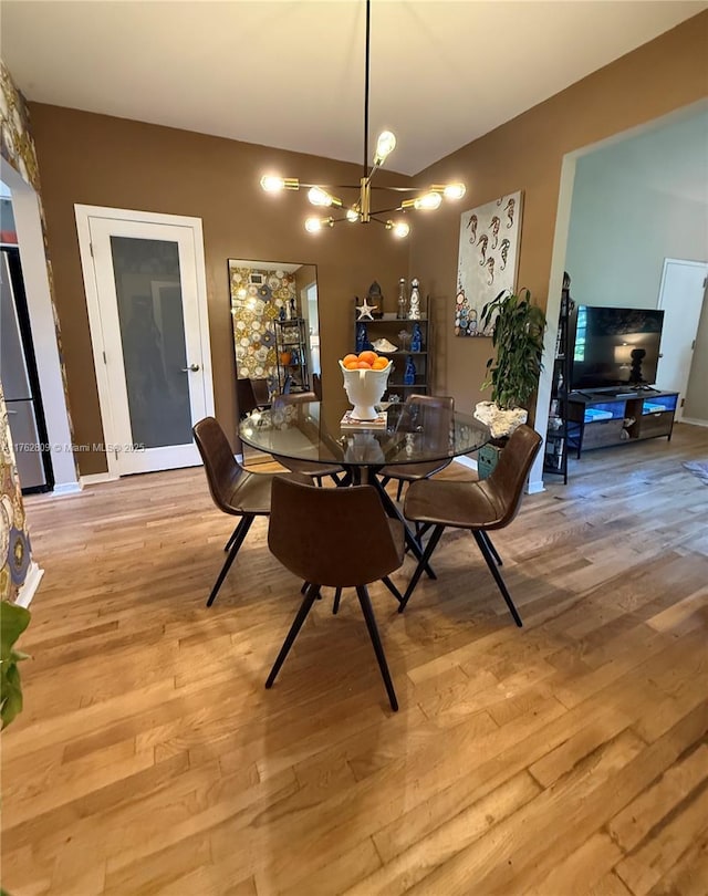 dining room with a notable chandelier and light wood-style floors