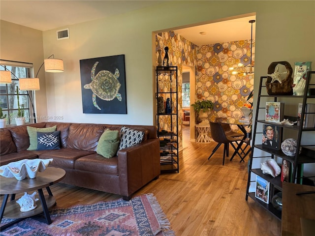 living area with visible vents and wood finished floors