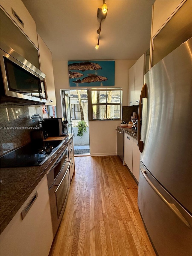 1600 Michigan Ave Unit 1, Miami Beach, FL 33139 - kitchen featuring stainless steel appliances, white cabinets, dark countertops, and tasteful backsplash