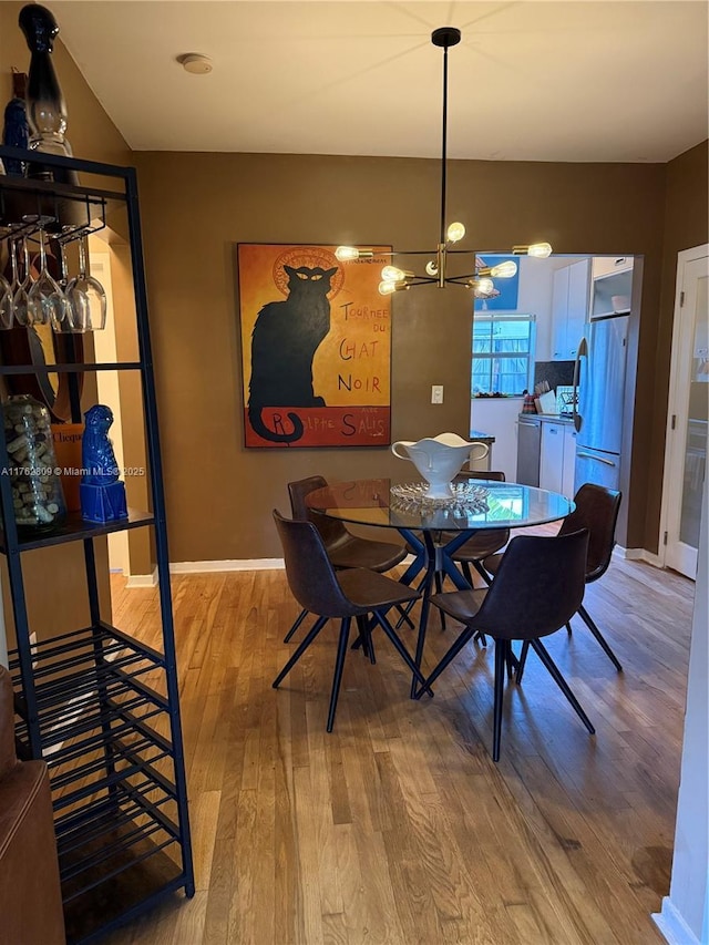 1600 Michigan Ave Unit 1, Miami Beach, FL 33139 - dining area featuring light wood-style flooring and a chandelier