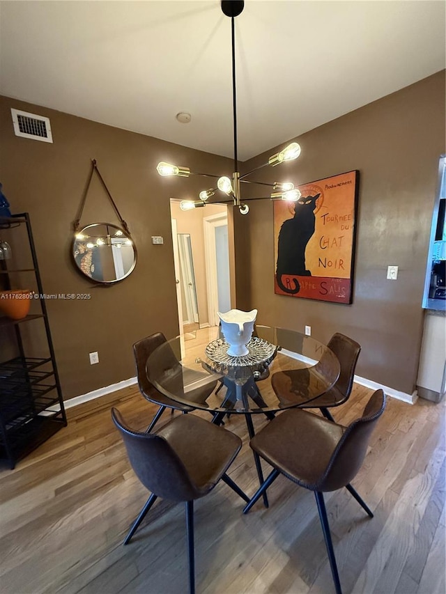 1600 Michigan Ave Unit 1, Miami Beach, FL 33139 - dining space featuring wood finished floors and a chandelier