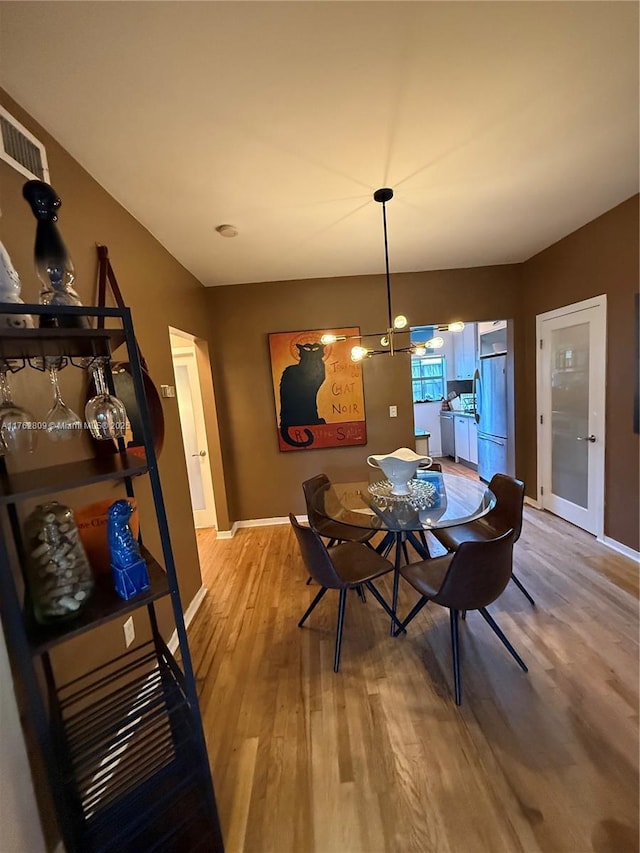 1600 Michigan Ave Unit 1, Miami Beach, FL 33139 - dining room with light wood-style floors and a chandelier