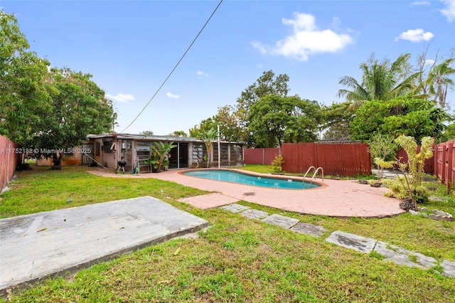 view of swimming pool featuring a fenced in pool, a patio, a lawn, and a fenced backyard