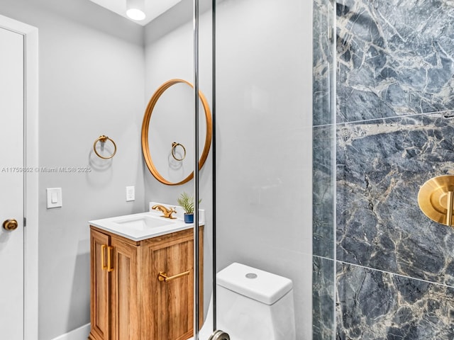 bathroom featuring vanity and toilet