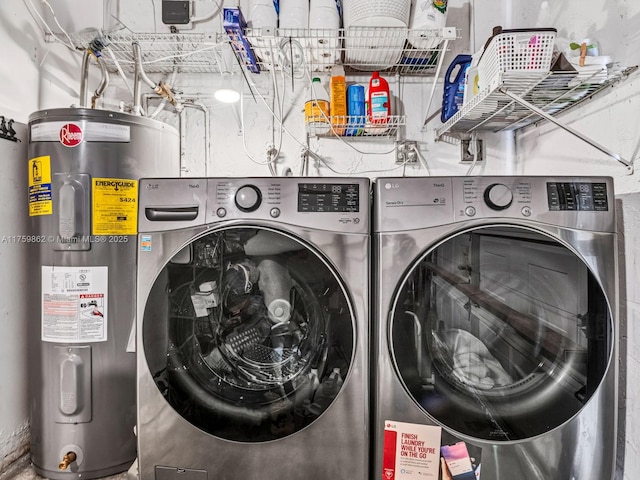 washroom featuring laundry area, washing machine and dryer, and electric water heater