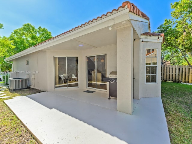 view of patio / terrace featuring central air condition unit and fence