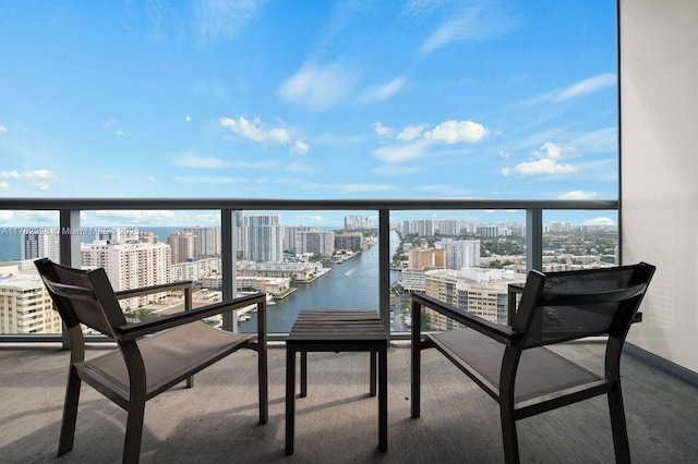 balcony featuring a city view and a water view