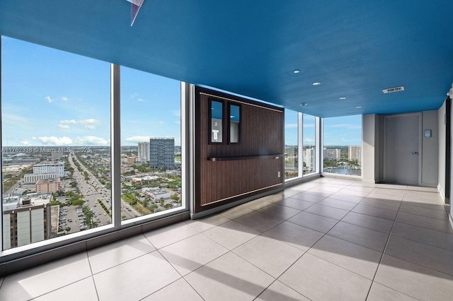 unfurnished sunroom with a city view and visible vents