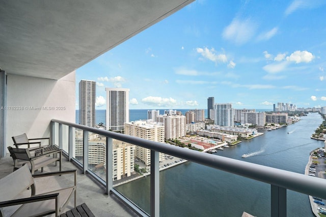 balcony featuring a view of city and a water view