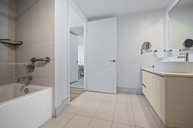 bathroom featuring tile patterned flooring, shower / washtub combination, and vanity