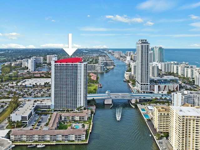 birds eye view of property featuring a view of city and a water view