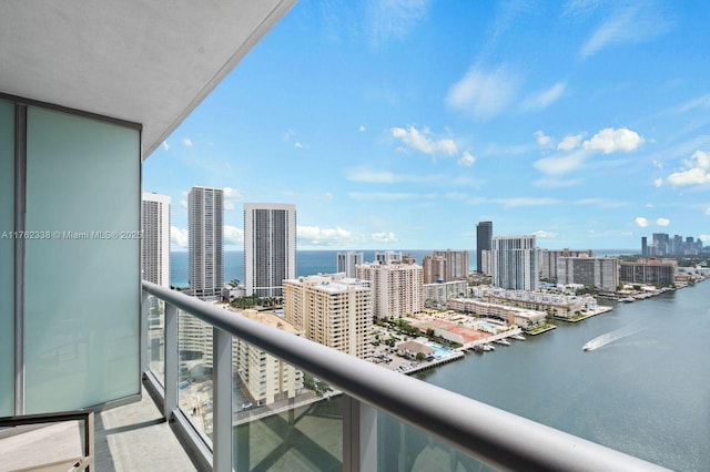 balcony featuring a city view and a water view