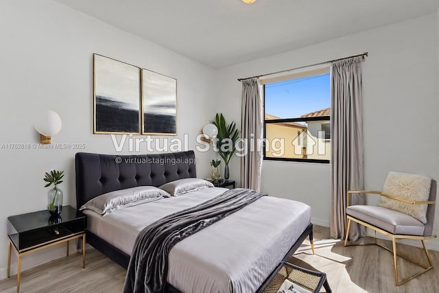 bedroom featuring baseboards and wood finished floors