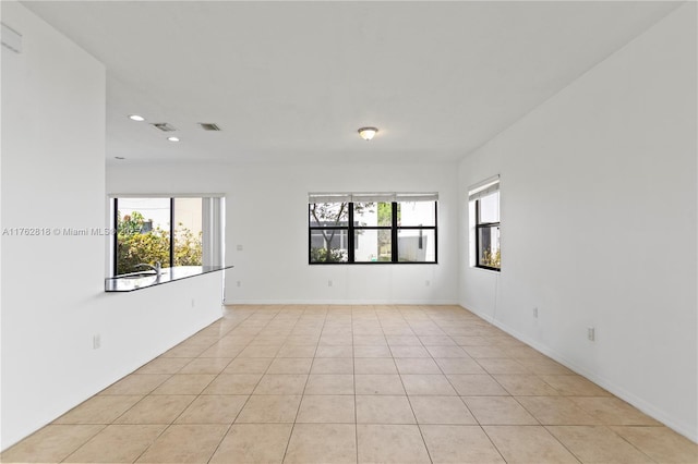 unfurnished room featuring recessed lighting, baseboards, visible vents, and light tile patterned floors