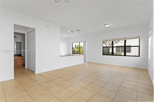 spare room featuring light tile patterned floors and recessed lighting