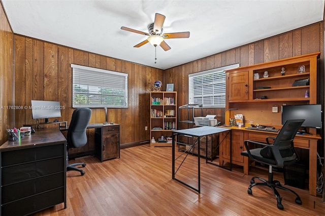 office with wood walls, light wood-type flooring, and ceiling fan