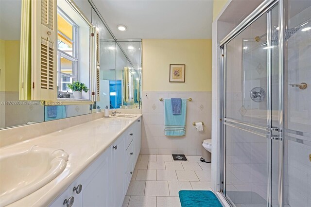 8470 SW 86th Ct, Miami, FL 33143 - full bathroom featuring a stall shower, tile patterned flooring, a sink, and tile walls