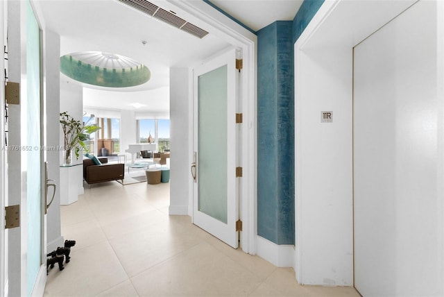 corridor with tile patterned floors and visible vents