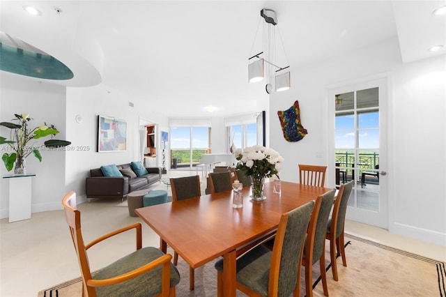 dining area with recessed lighting, a healthy amount of sunlight, and baseboards