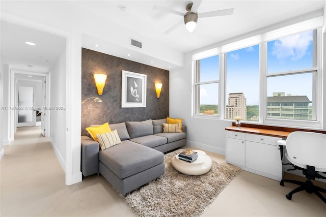 living area featuring baseboards, visible vents, wallpapered walls, recessed lighting, and an accent wall