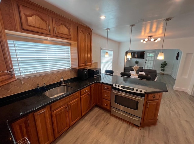 kitchen featuring a sink, appliances with stainless steel finishes, and brown cabinetry