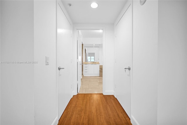 corridor featuring light wood-style flooring