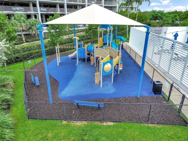 communal playground featuring central air condition unit and fence