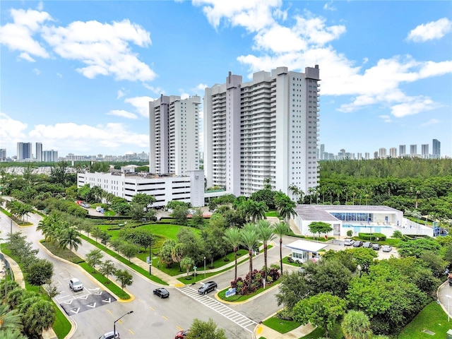 view of property featuring uncovered parking and a city view