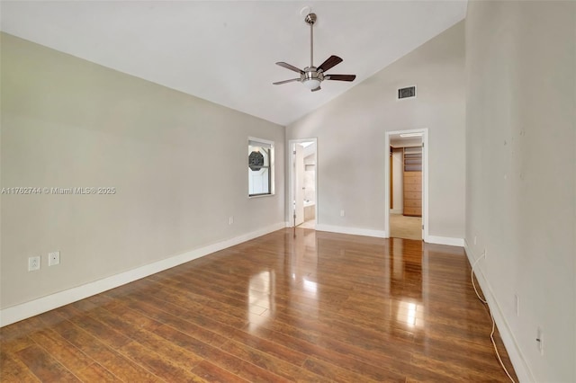 spare room with visible vents, baseboards, wood finished floors, high vaulted ceiling, and a ceiling fan