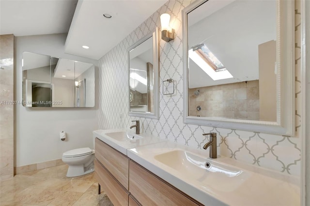 full bathroom featuring a sink, baseboards, toilet, and wallpapered walls