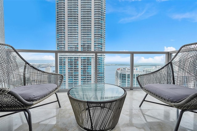 balcony featuring a view of city and a water view