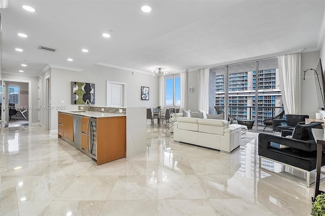 kitchen featuring visible vents, ornamental molding, a sink, open floor plan, and brown cabinetry