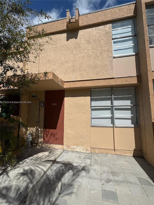 exterior space featuring a patio and stucco siding