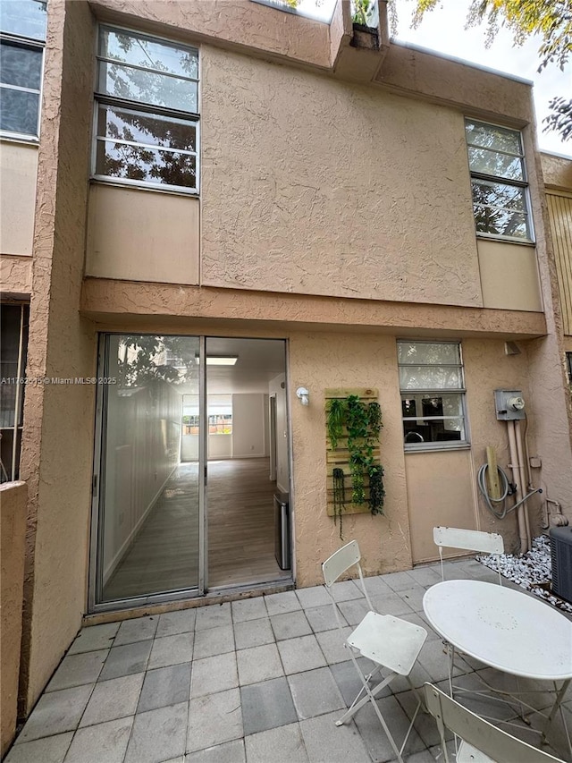 back of property featuring stucco siding and a patio