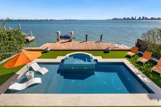 view of pool with a pool with connected hot tub, a dock, and a water view