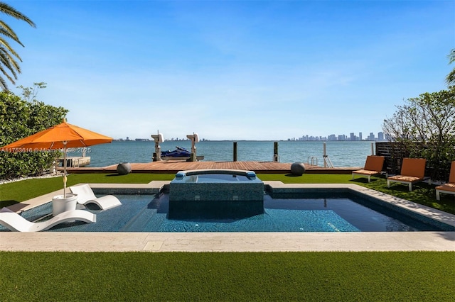 view of swimming pool featuring a yard, a water view, an in ground hot tub, and a dock