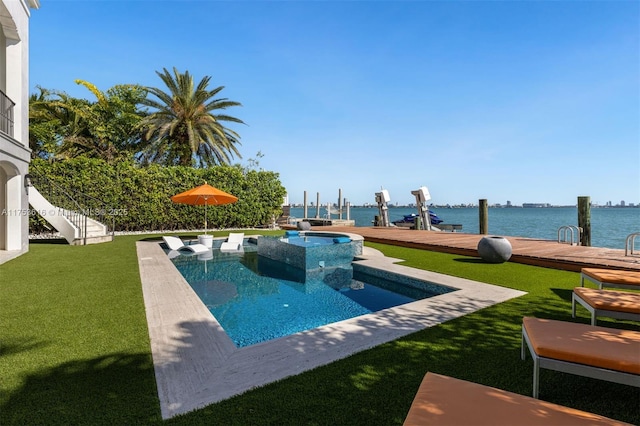 view of pool featuring boat lift, a dock, a yard, and a water view