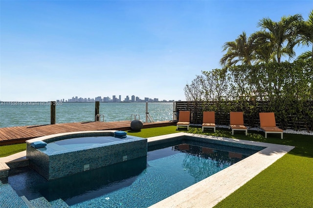 view of pool featuring a water view and a pool with connected hot tub