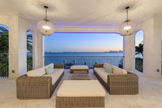 patio terrace at dusk with a water view and an outdoor hangout area