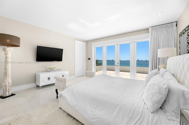 bedroom featuring baseboards and access to outside