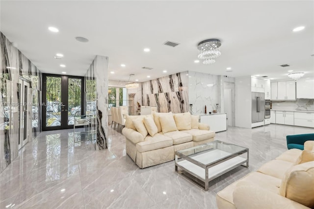 living area featuring french doors, recessed lighting, visible vents, and marble finish floor