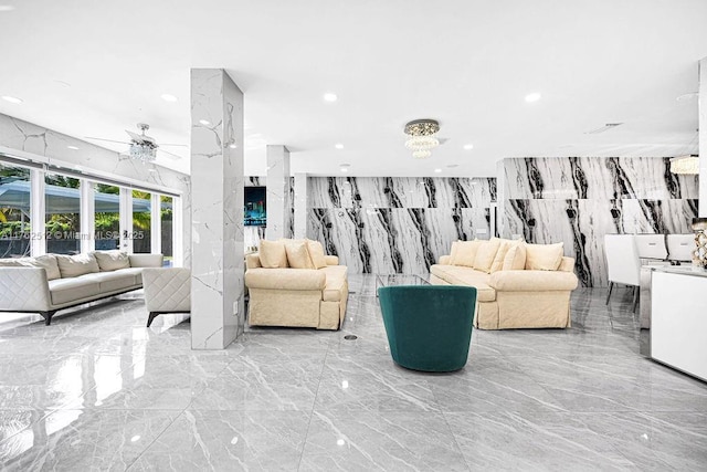 living room featuring a ceiling fan, stone wall, recessed lighting, and marble finish floor