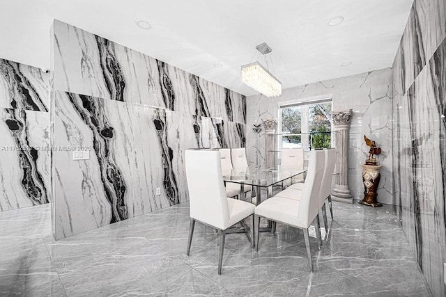 dining room featuring recessed lighting, marble finish floor, stone wall, and tile walls