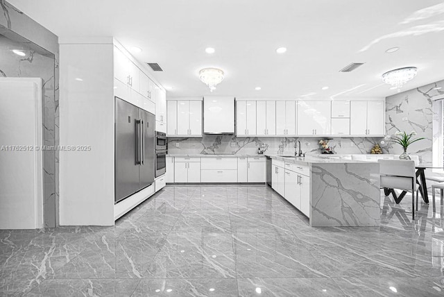 kitchen with white cabinets, high quality fridge, visible vents, and marble finish floor